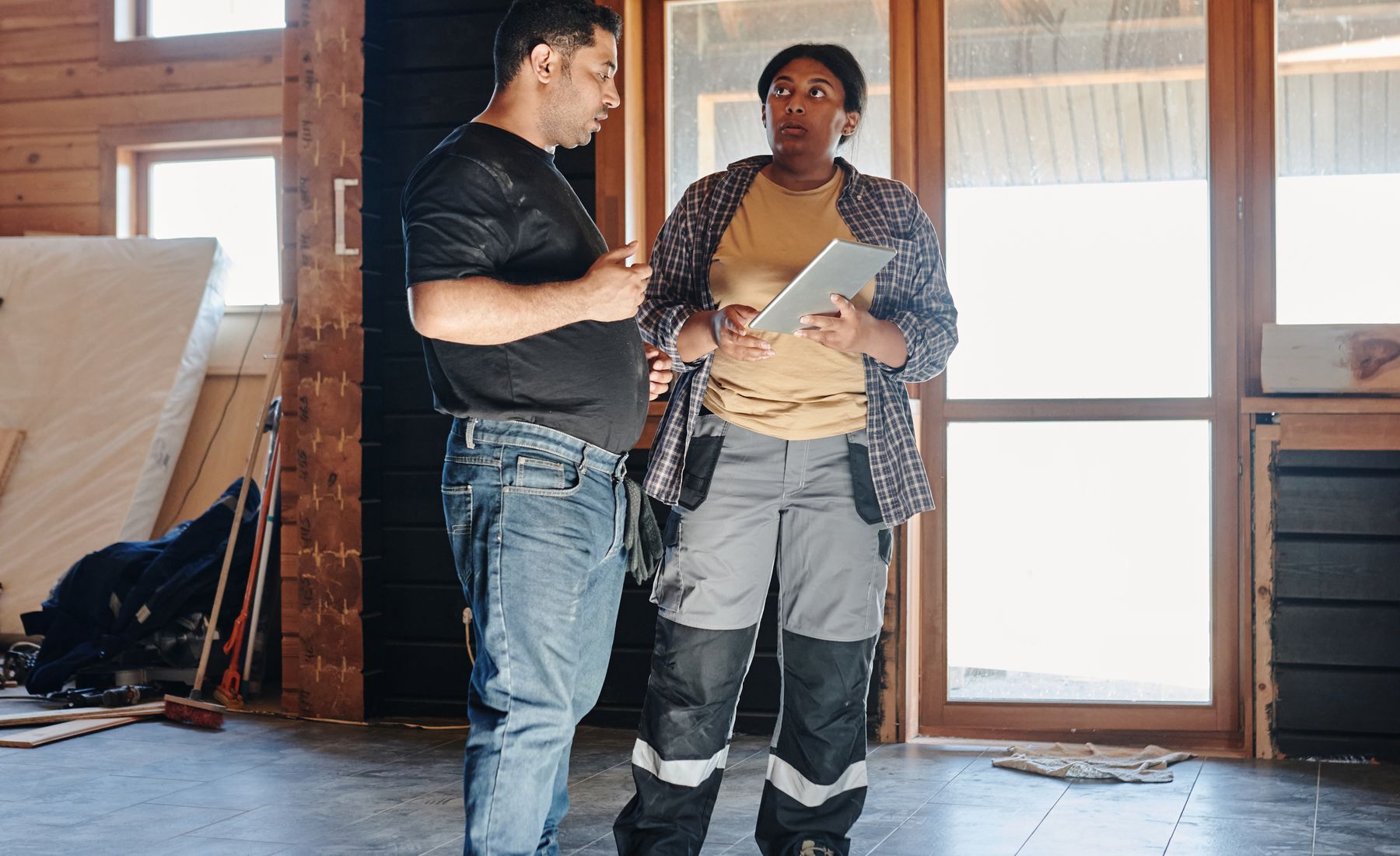 Two professional contractors reviewing a residential renovation project
